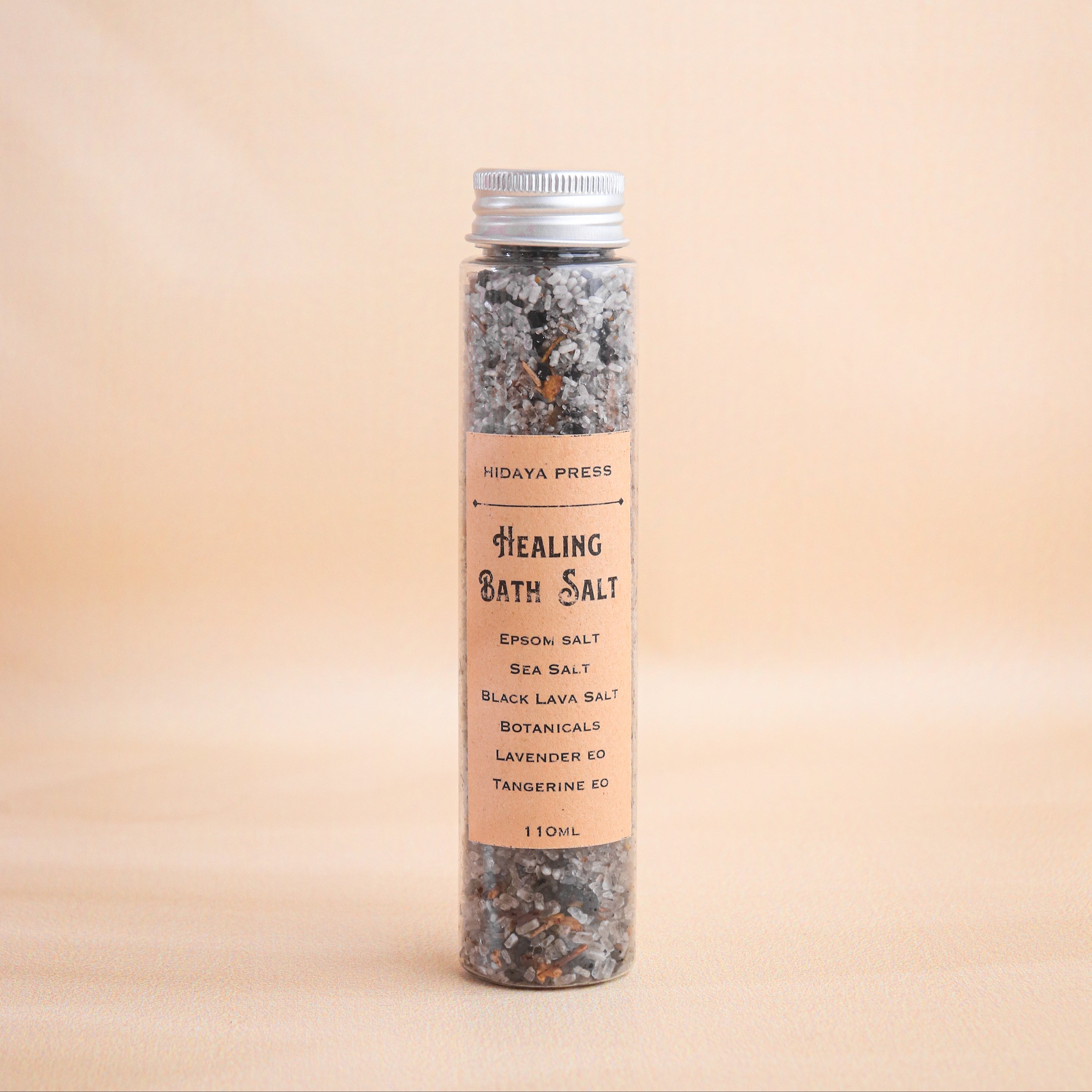 Healing bath salt container with label on a beige background