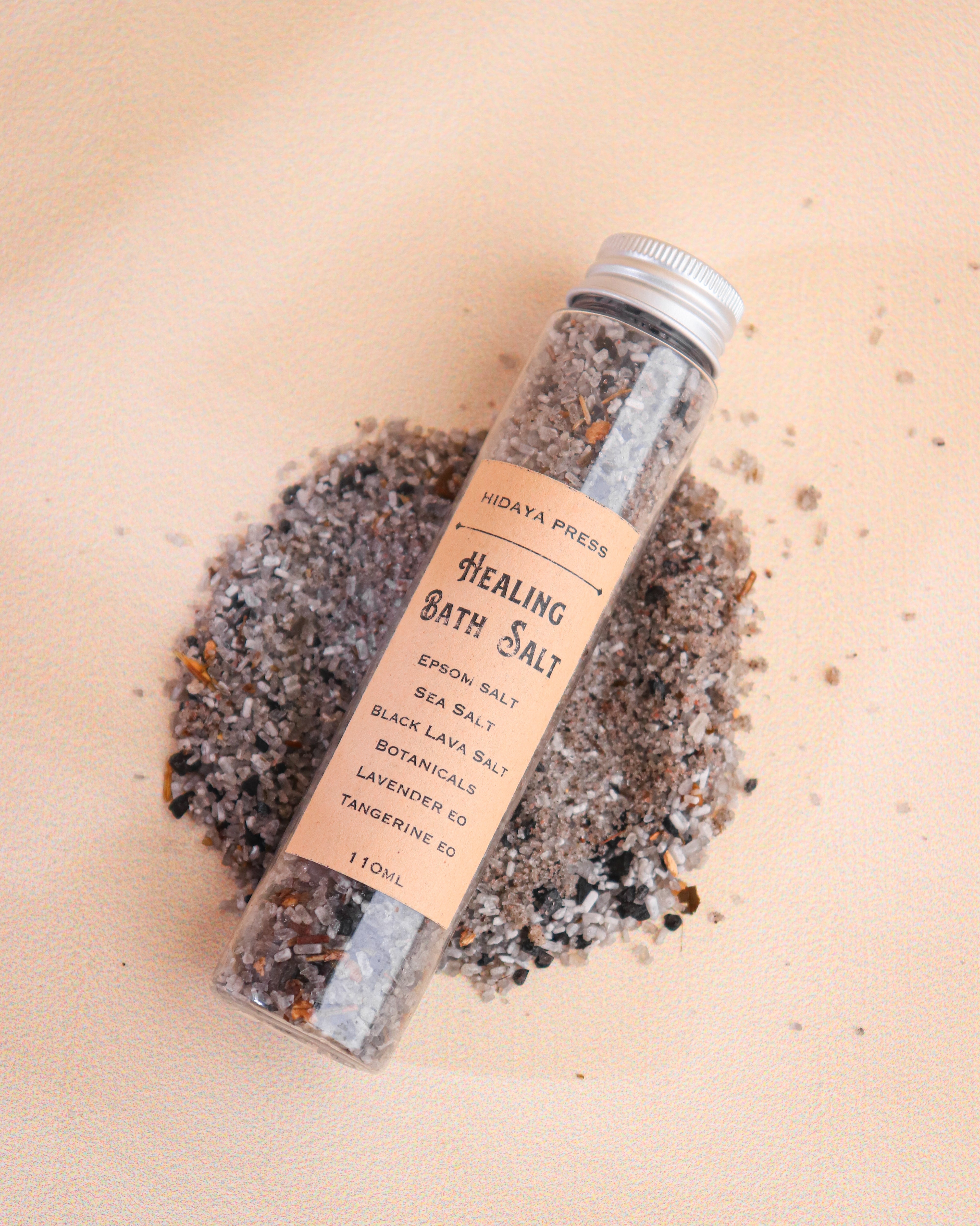 Healing bath salt container with a label on a beige background