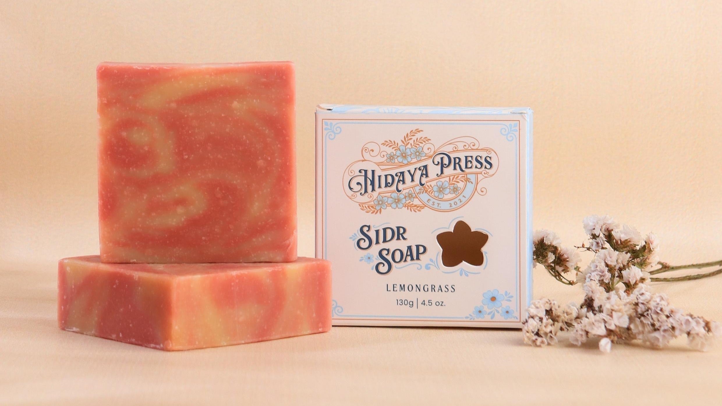 Two bars of soap and a box labeled 'Hidaya Press' on a beige background