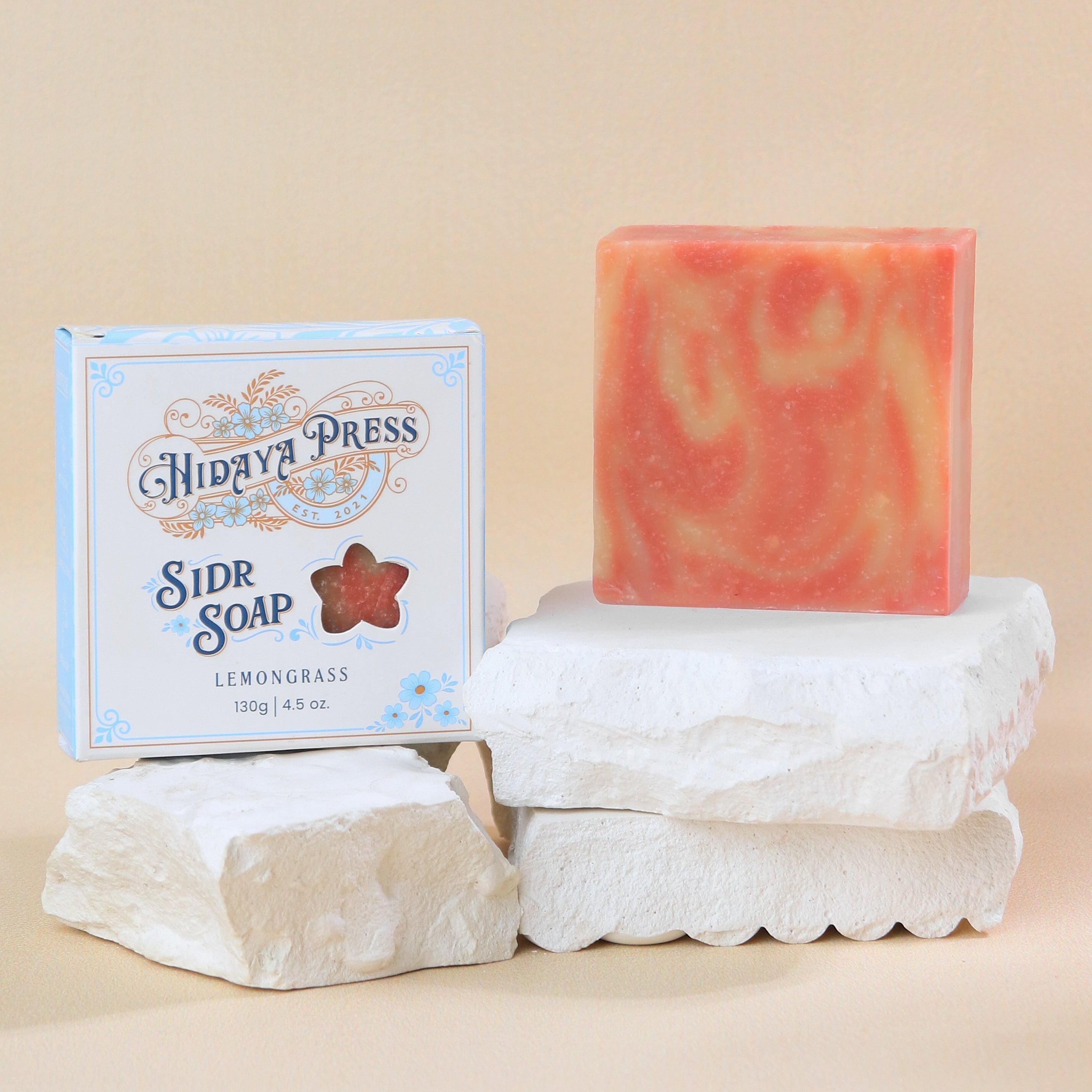Bar of soap with a box labeled 'Hidaya Press' on a beige background