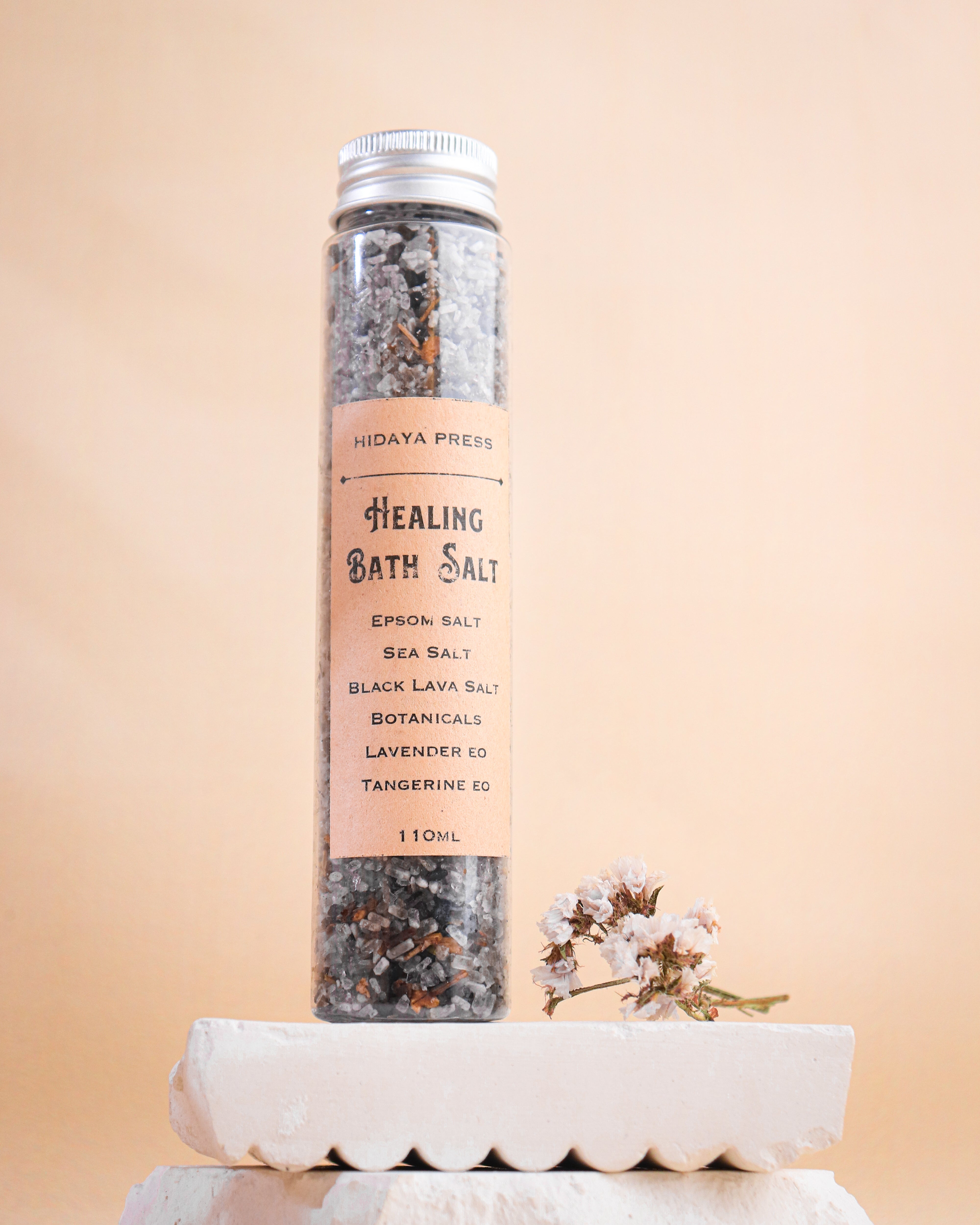 Bottle of 'Healing Bath Salt' by Hidaya Press on a beige background