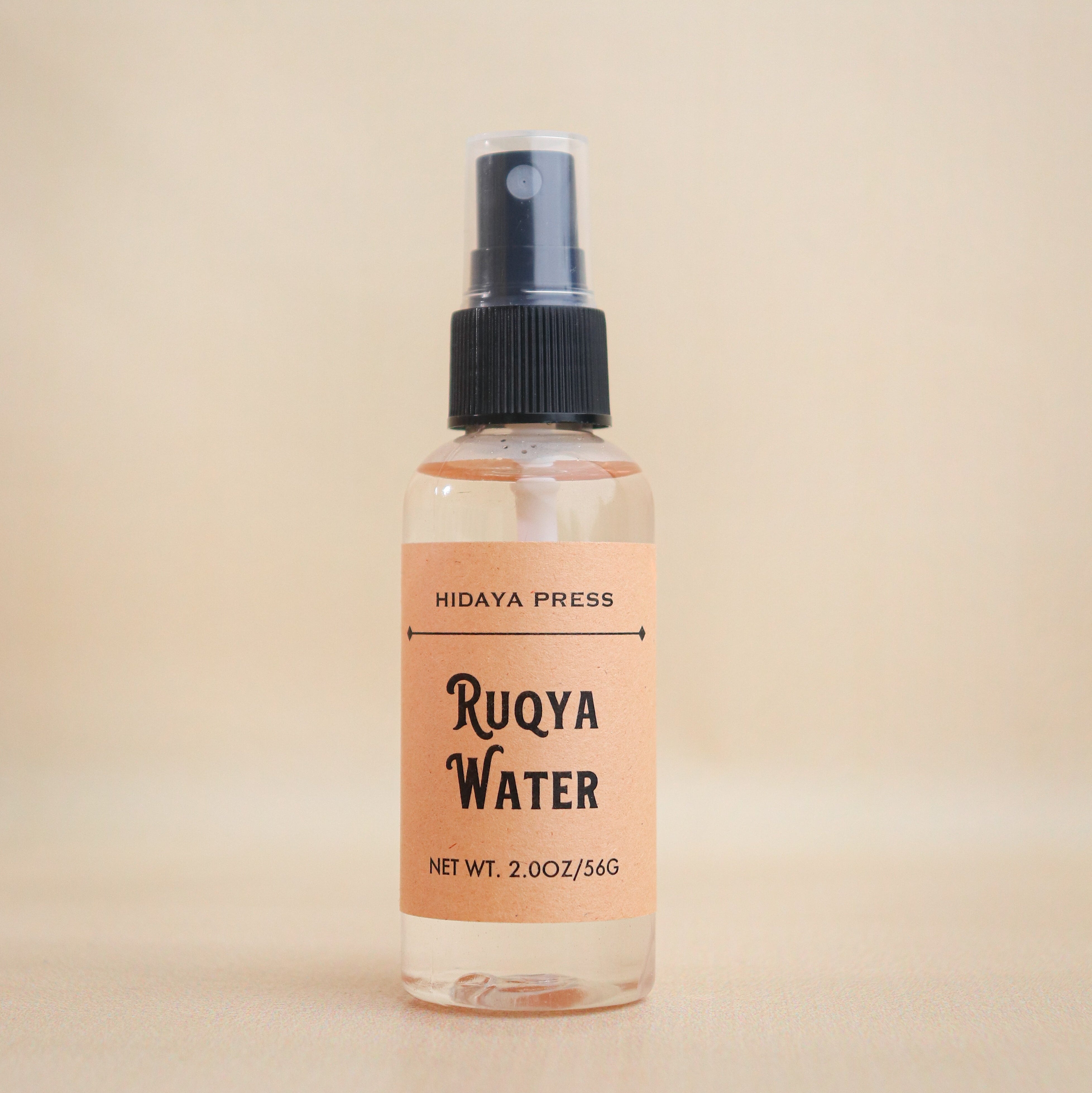 Bottle of Ruqya Water with a label on a beige background